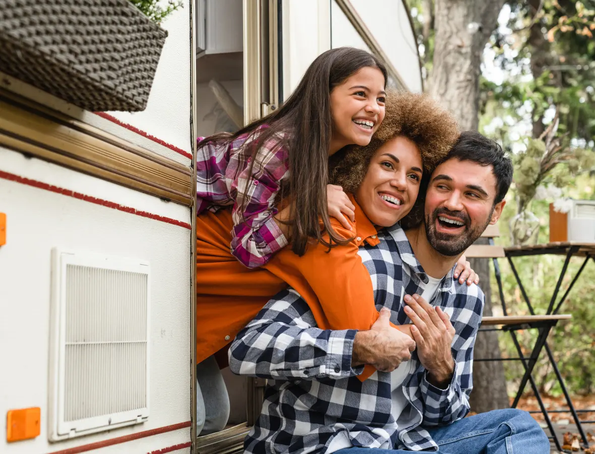 Family sitting outside their RV