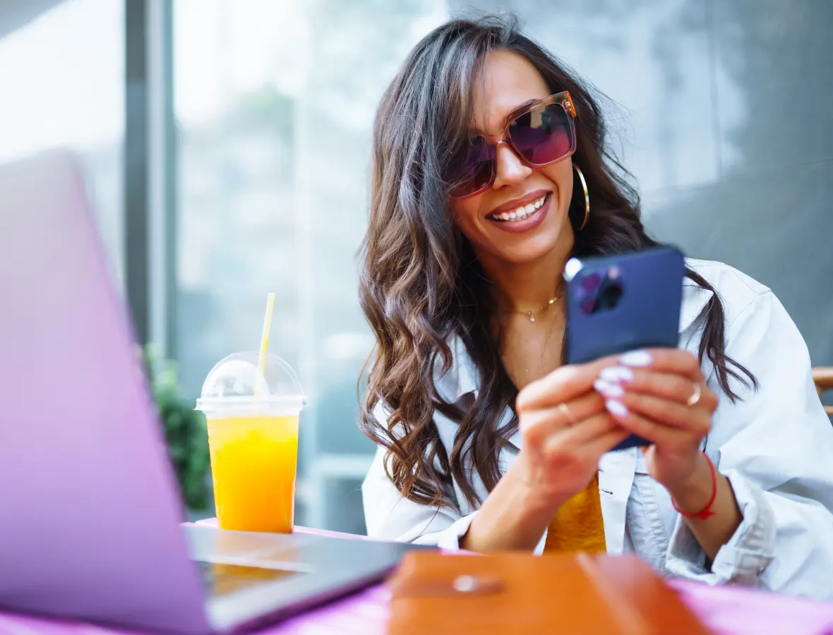 lady looking at her phone and sitting outside