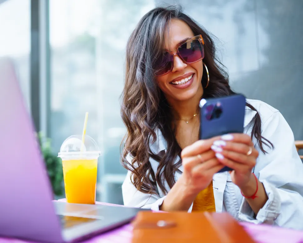 Woman smiling at her phone while working