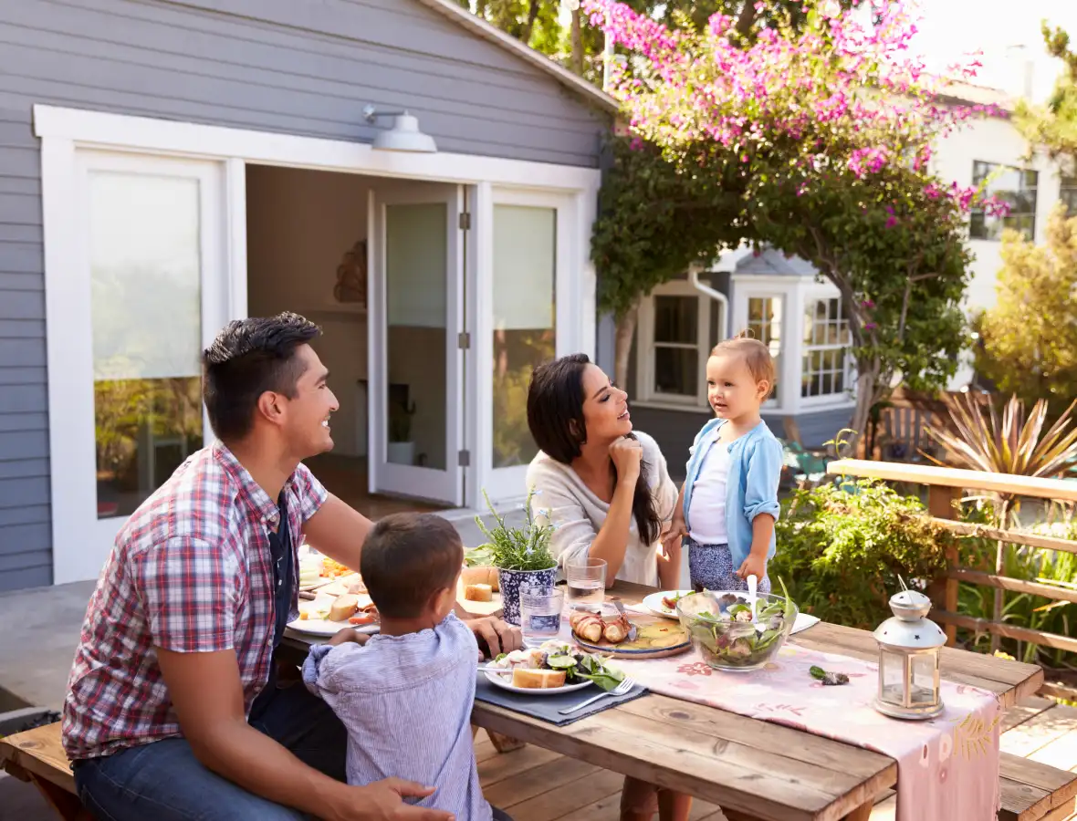 family sitting outside on their patio