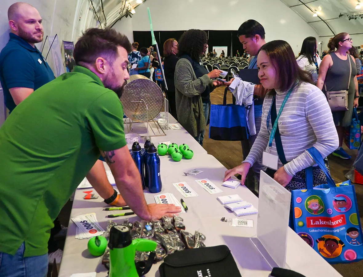 SSSCU employee helping a new teacher at an event