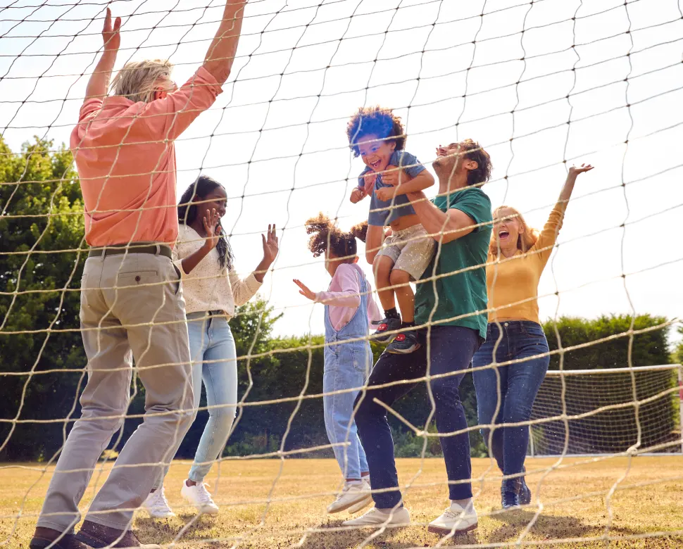 Multi-generational family playing soccer