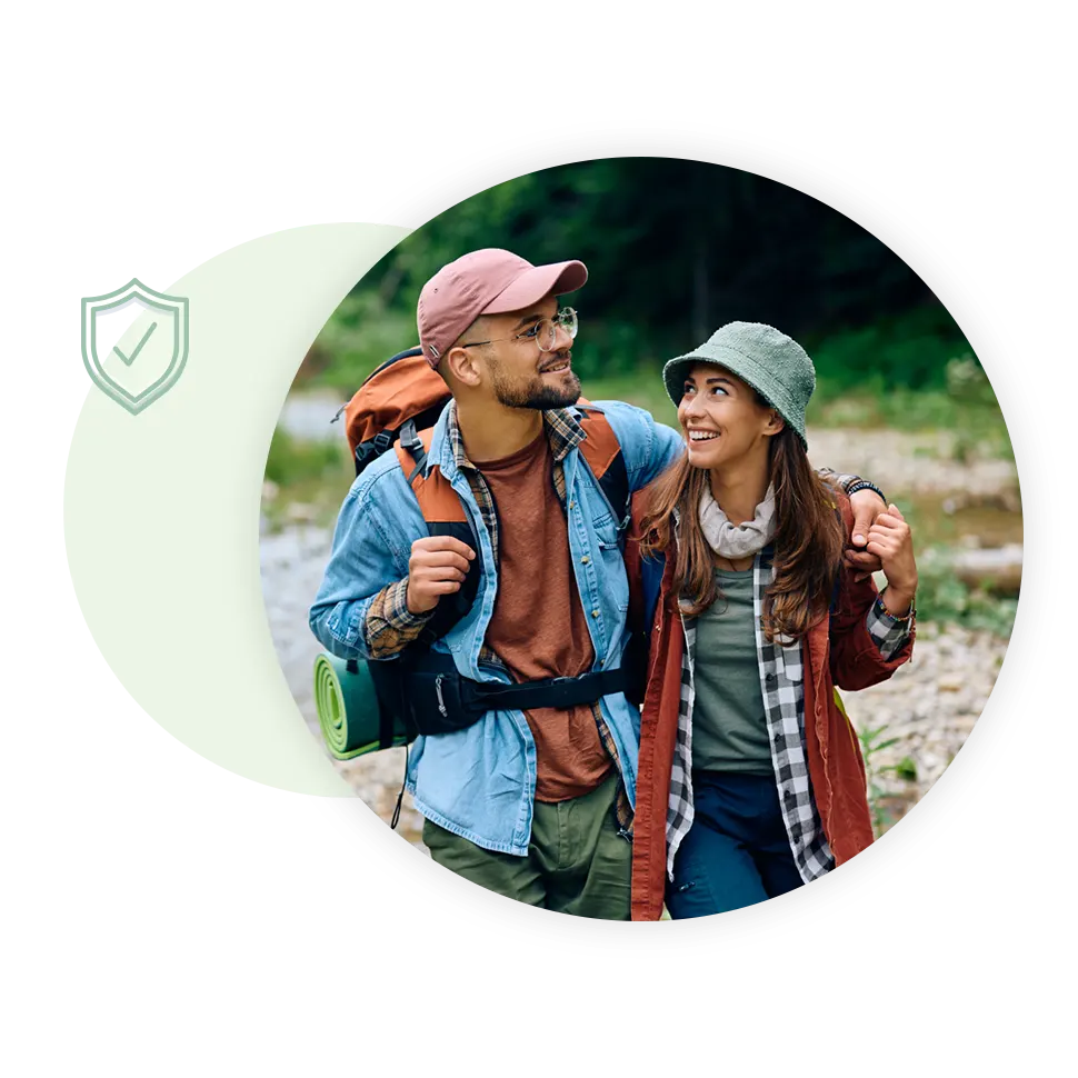 Couple on a hiking adventure with money saved in a Regular Savings account.