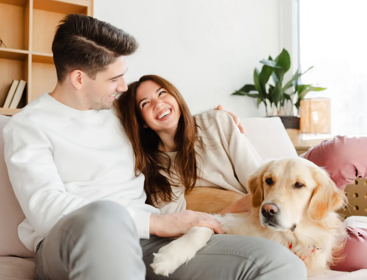 Couple relaxing on the couch with their dog