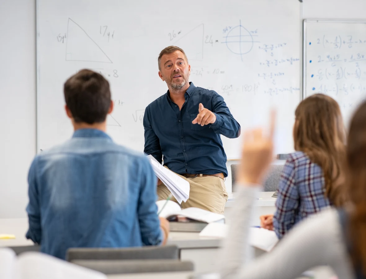 Teacher in classroom with adult students