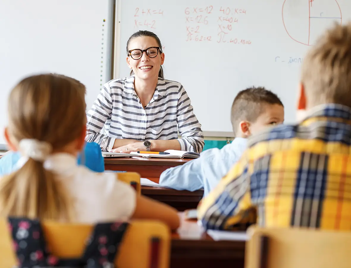 Teacher laughing with kids