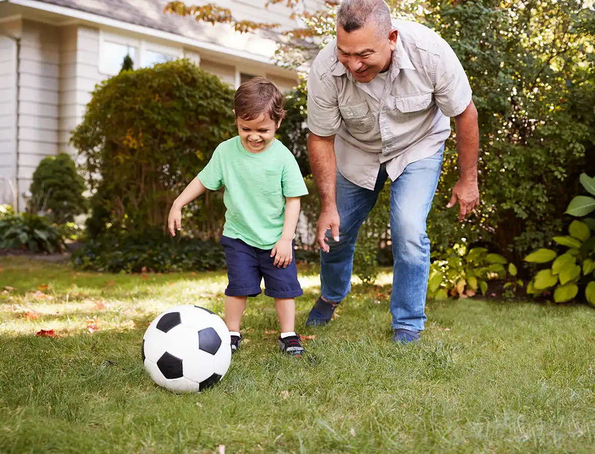 father and son playing soccer