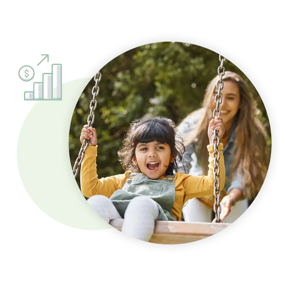 Mom pushing daughter on swing